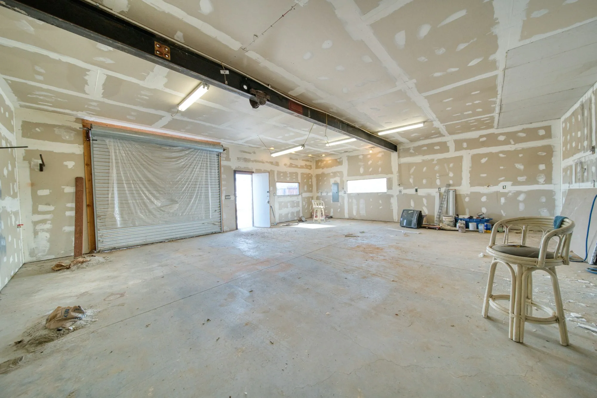 Garage interior with freshly hung drywall, every joint taped and floated